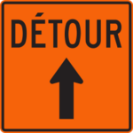 Sign with an orange background showing an arrow pointing in the direction of the detour.