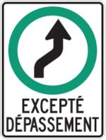 Sign with a white background showing an arrow curved to the right inside a green circle with the words “excepté dépassement.”