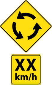 Road sign indicating the upcoming intersection and the recommended speed.