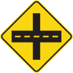 Sign with yellow background showing a road crossing a trail