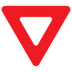 Red triangle-shaped sign with a white triangle inside.