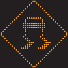 Un pictogramme lumineux en forme de losange. Une automobile en son centre donne l’impression de glisser de façon non contrôlée.