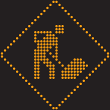 Un pictogramme lumineux en forme de losange. En son centre, un ouvrier manie une pelle.